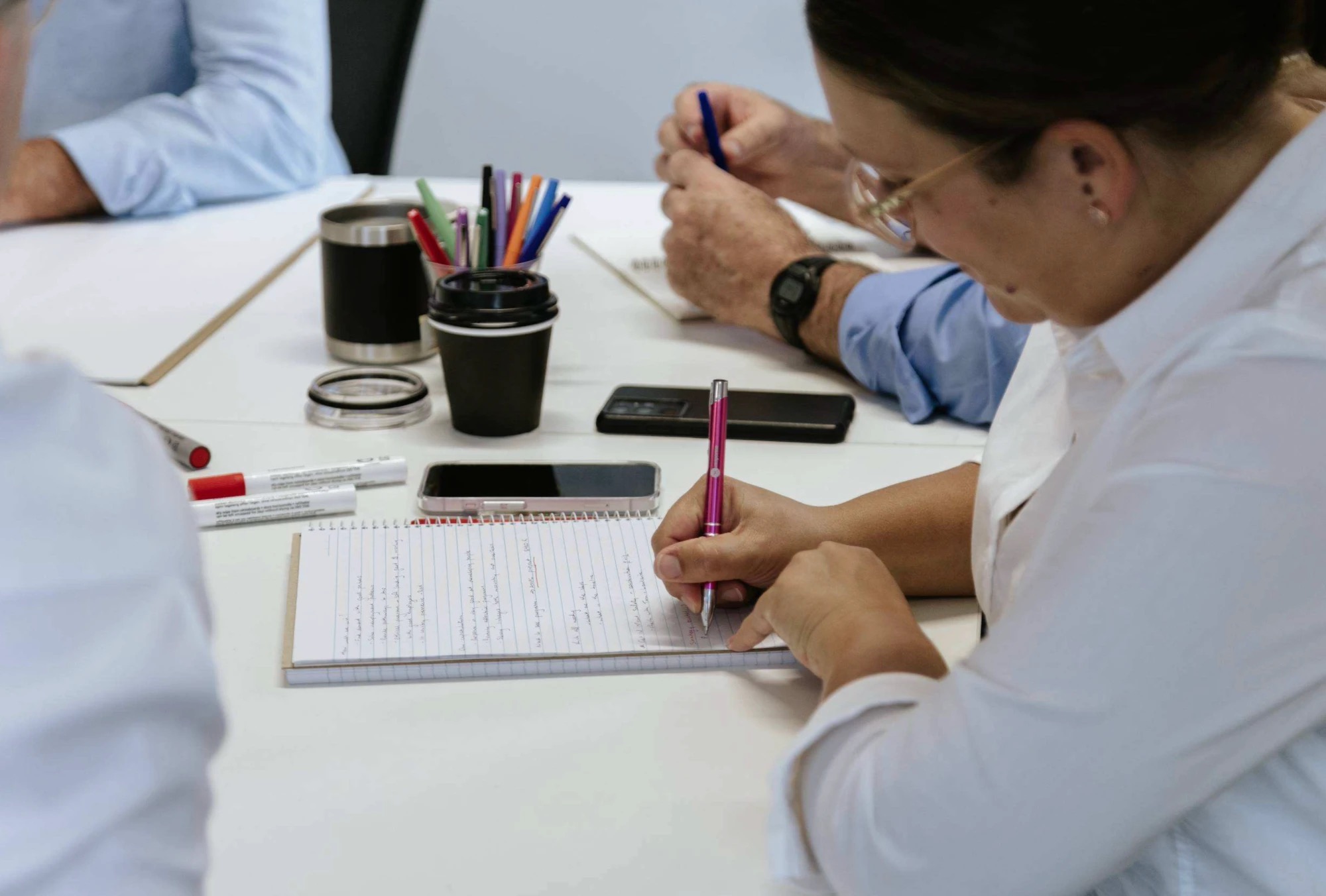 A participant taking handwritten notes during a Response workshop
