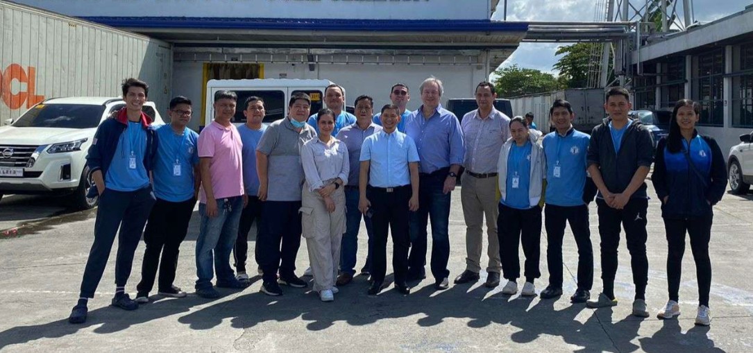 Response Group team members and workers outside a processing site in the Philippines